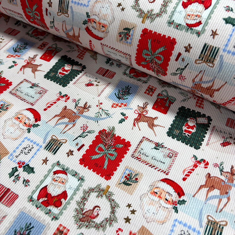 A close-up of a Christmas-themed fabric with a white ribbed background and a colorful patchwork print featuring Santa Claus, reindeer, wreaths, candy canes, stockings, and holiday motifs.