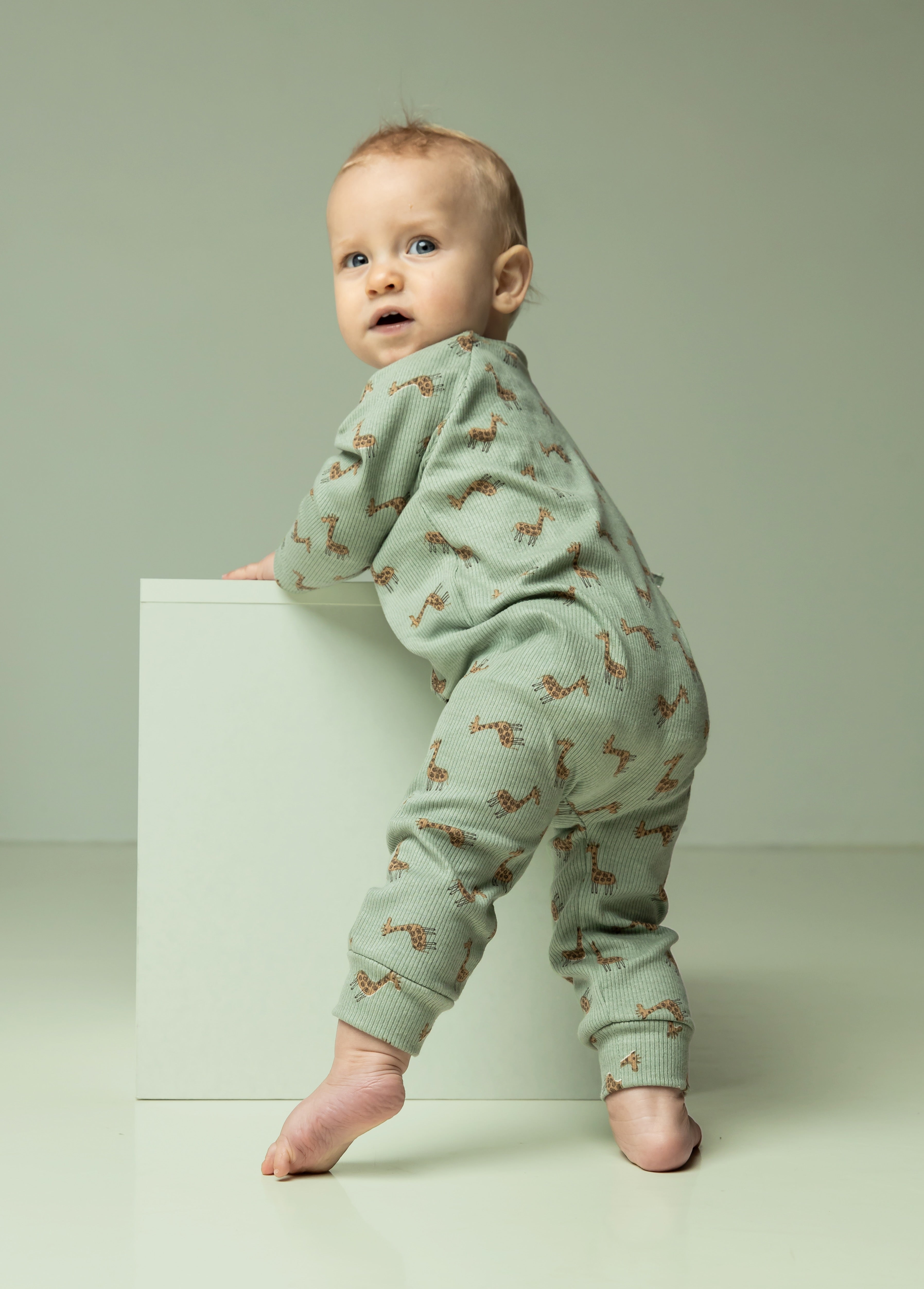 Baby wearing giraffe print jersey top