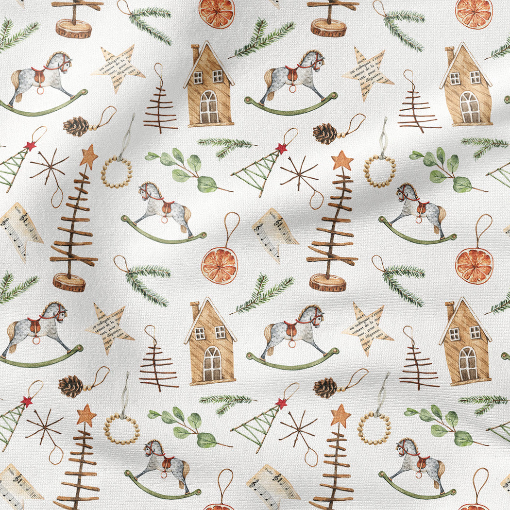A repeating Christmas-themed pattern on a white fabric background, featuring brown rocking horses, small houses, pine trees, ornaments, stars, and green evergreen branches.