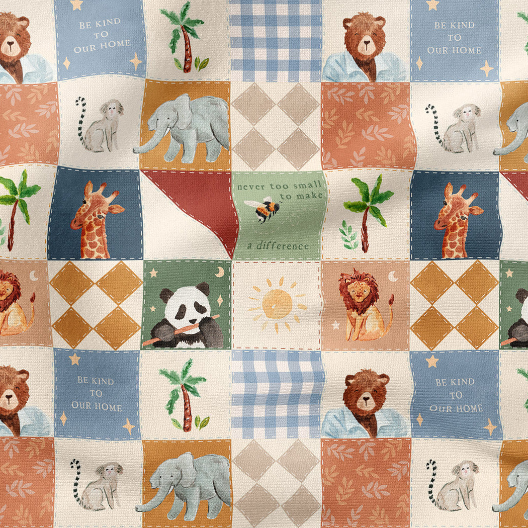 A close-up of a patchwork fabric featuring various animal illustrations including pandas, giraffes, lions, elephants, and bears, alongside palm trees, suns, and text like 'BE KIND TO YOUR HOME' in a retro quilted pattern.