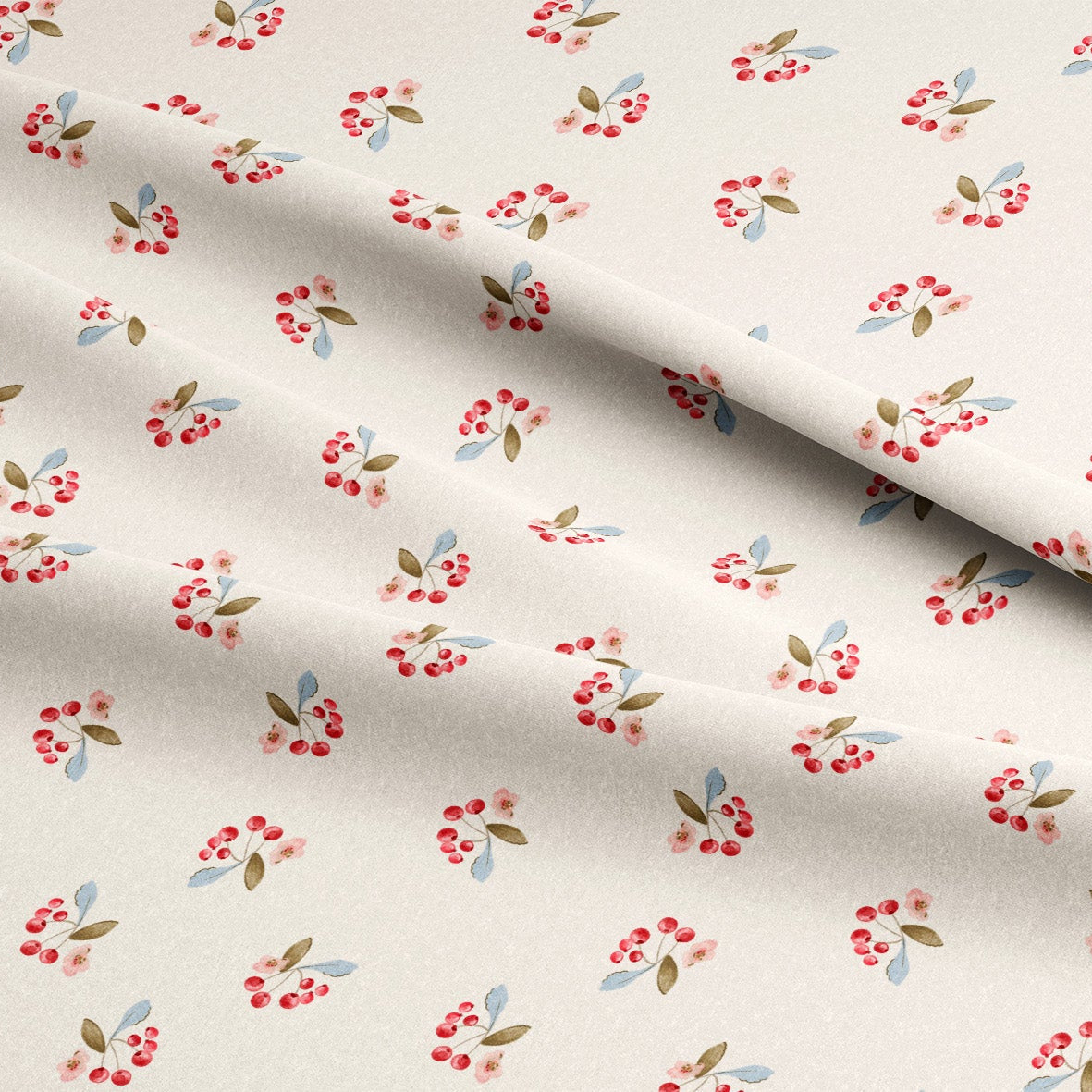 Floral patterned fabric with cherries and green leaves on a beige background