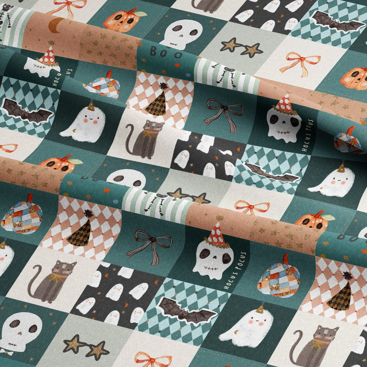 A close-up of a folded fabric with a repeating Halloween-themed patchwork print. The pattern features squares with ghosts, cats, skulls, bats, pumpkins, stars, and candy motifs in teal, beige, white, black, and orange tones.
