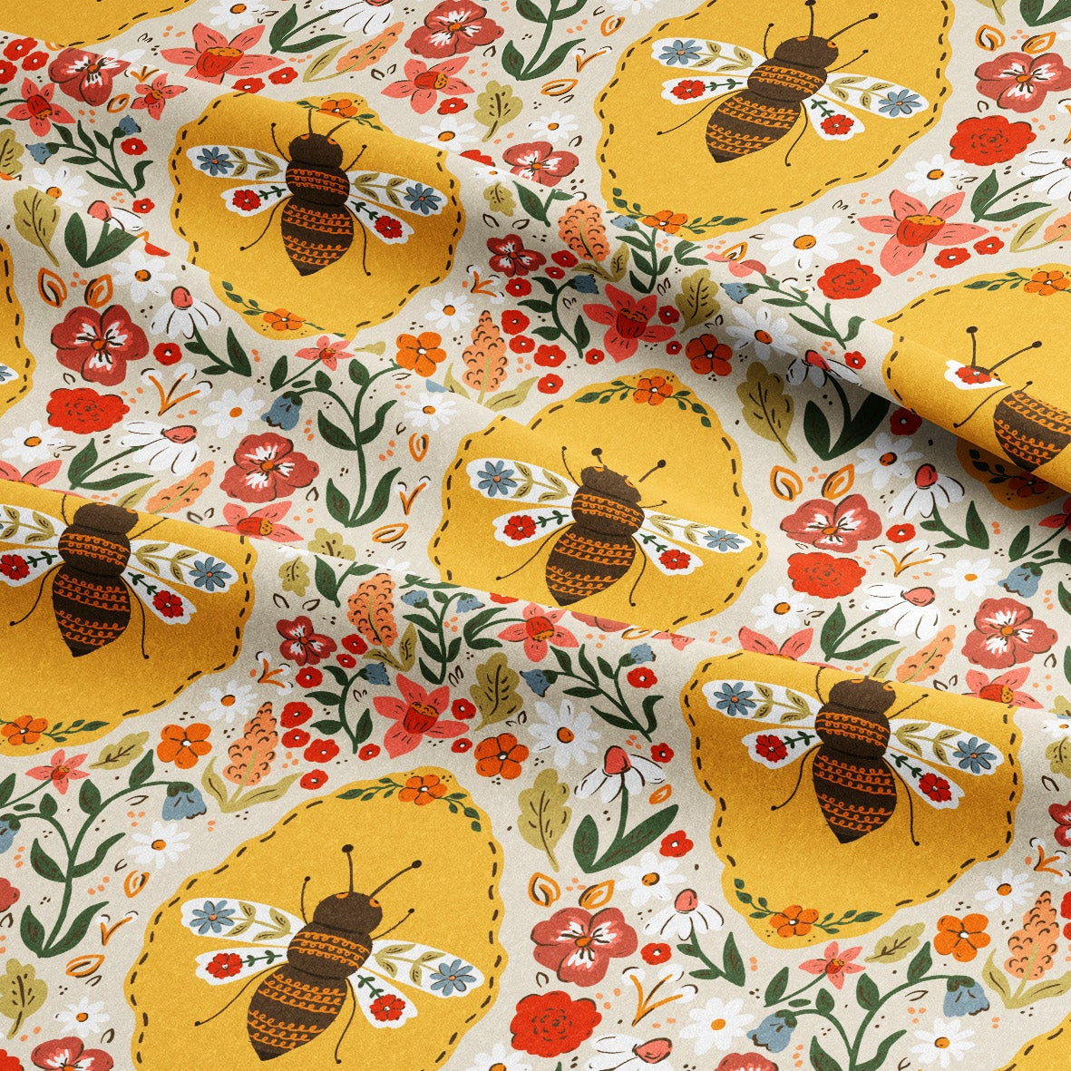 A close-up of patterned fabric with a repeating design of yellow bees, red and orange flowers, green leaves, and small blue accents on a white background.