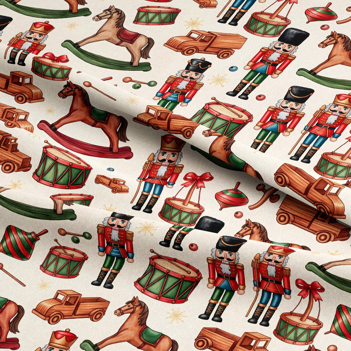 A close-up of a fabric or wallpaper pattern featuring a repeating design of classic Christmas toy motifs, including nutcrackers, rocking horses, toy trucks, and drums on an off-white background.
