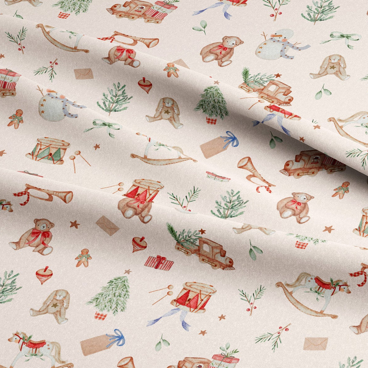 A close-up of a fabric with a festive Christmas pattern featuring teddy bears, rocking horses, sleighs, snowman, Christmas trees, and gifts on an off-white background.