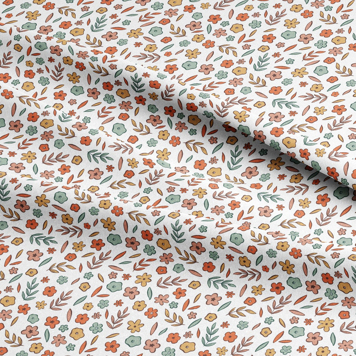 Floral patterned fabric with small flowers and leaves on a white background