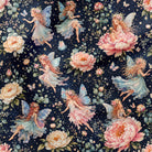 A close-up of a fabric pattern featuring fairies with wings and large pink and cream peonies on a dark navy blue background.