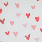 Pattern of pink hearts on white ribbed fabric