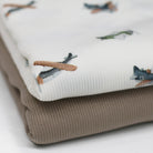 White fabric with toy airplane print
