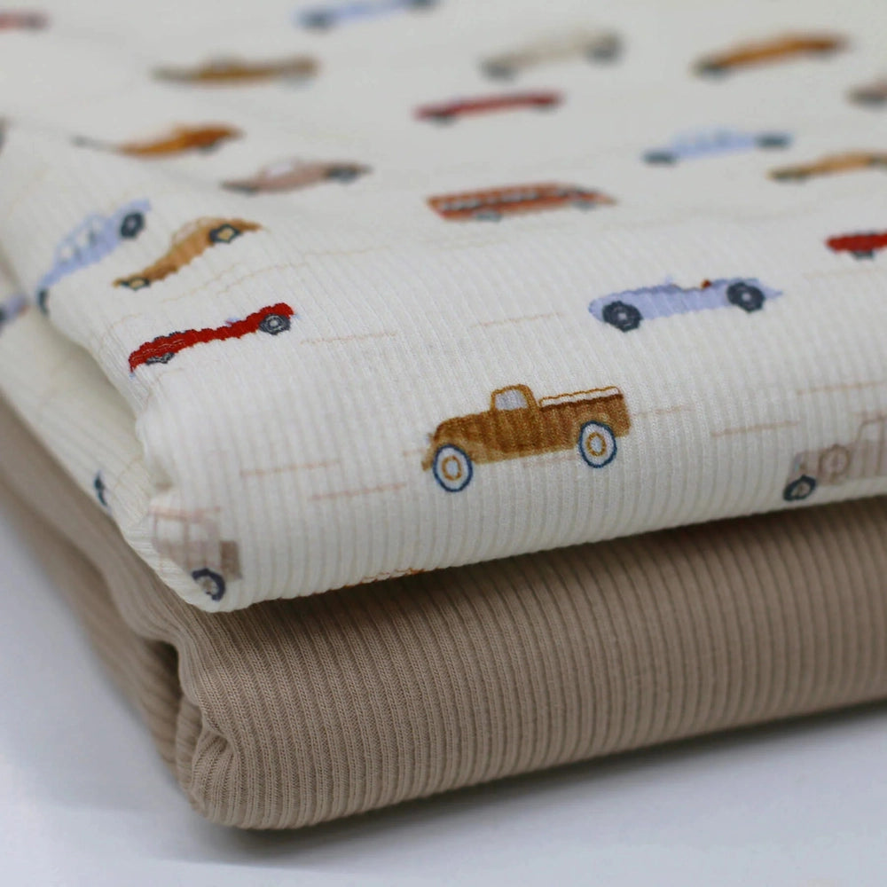 White ribbed jersey fabric with colorful car and vehicle print, suitable for children's clothing and crafts