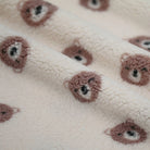 Close-up of teddy bear face on soft fabric