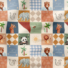 A close-up of a patchwork fabric featuring various animal illustrations including pandas, giraffes, lions, elephants, and bears, alongside palm trees, suns, and text like 'BE KIND TO YOUR HOME' in a retro quilted pattern.