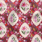 A close-up of a floral fabric pattern featuring cream-colored scalloped oval medallions with pink flowers and green leaves, set against a dark red background filled with smaller multicolored blossoms.