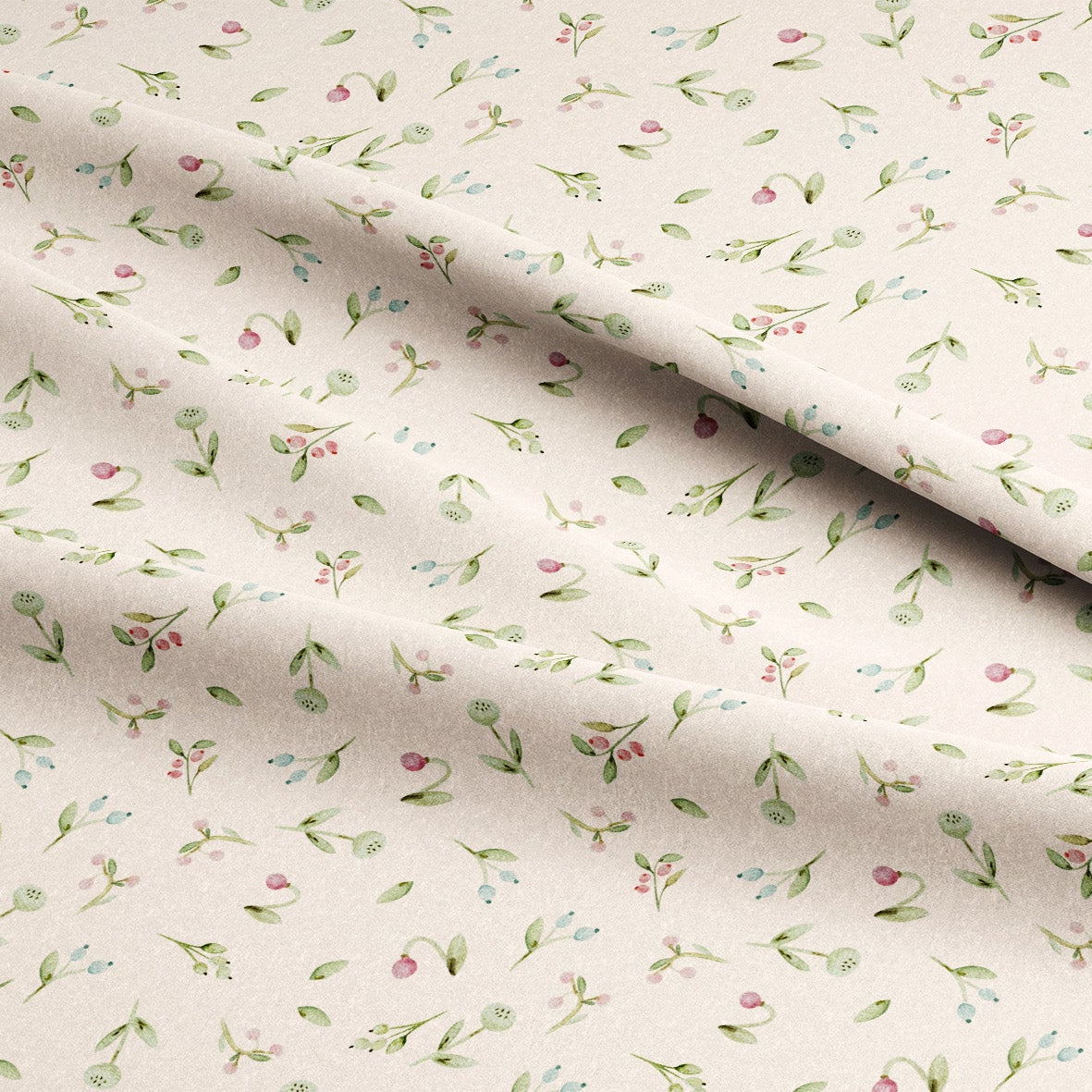 A close-up of draped fabric with a delicate all-over floral print on a warm cream background. The pattern features small green leaves, pink blossoms, and light blue flowers.