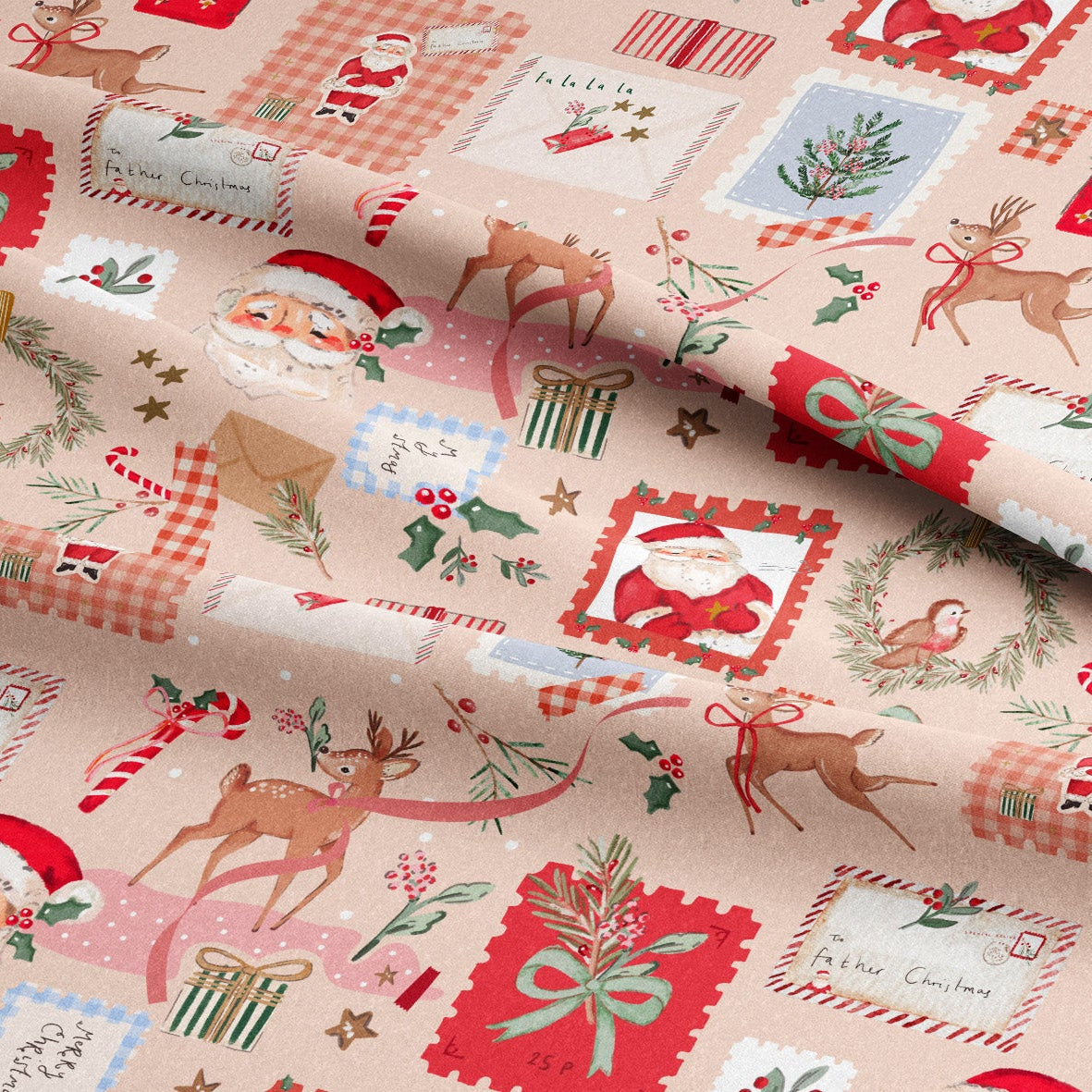 A close-up of a folded piece of Christmas-themed fabric with a light beige background and a repeating pattern of Santa Claus, reindeer, wreaths, candy canes, stockings, and postage-style stamps in red, green, blue, and cream.