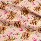 Highland cows with floral crowns on pink jersey fabric