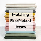 Stack of folded fabric with 'Matching Fine Ribbed Jersey' text overlay