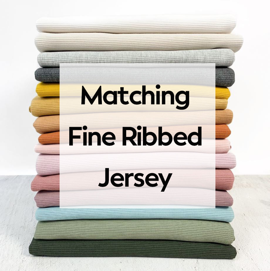 Stack of folded fabric with 'Matching Fine Ribbed Jersey' text overlay