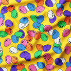 Colorful pattern of multicolored eggs on a yellow fabric background