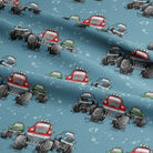 Fabric with cartoon monster truck pattern on a blue background