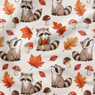 A repeating pattern of watercolor-style raccoons, autumn leaves, and mushrooms on an off-white fabric background. The raccoons are gray and black, surrounded by orange, red, and brown leaves, red-and-white mushrooms, and small brown mushrooms.