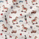A close-up of a fabric pattern featuring vintage toy illustrations including rocking horses, toy trucks, nutcrackers, candy canes, and stars on an off-white background.