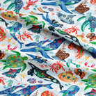 Colorful fabric with sea-themed pattern featuring various marine animals and ships.