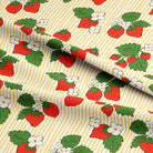 Fabric with strawberry pattern on a yellow and white striped background